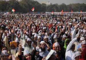 Supporters of Aam Aadmi Party cheer during the swearing in ceremony of party leader Arvind Kejriwal as chief minister of Delhi in New Delhi. The AAP, headed by the former tax official who had remade himself into a champion for clean government, won 67 of the 70 seats in recent elections.