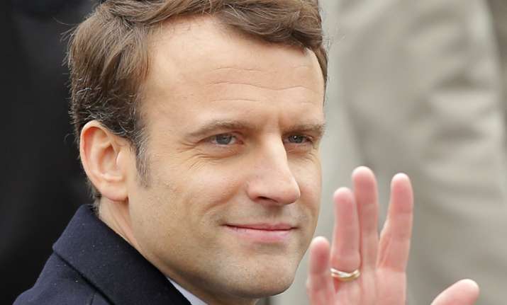 French president-elect Emmanuel Macron waves while