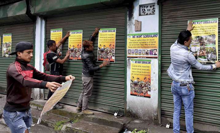 GJM activists paste party posters during indefinite strike
