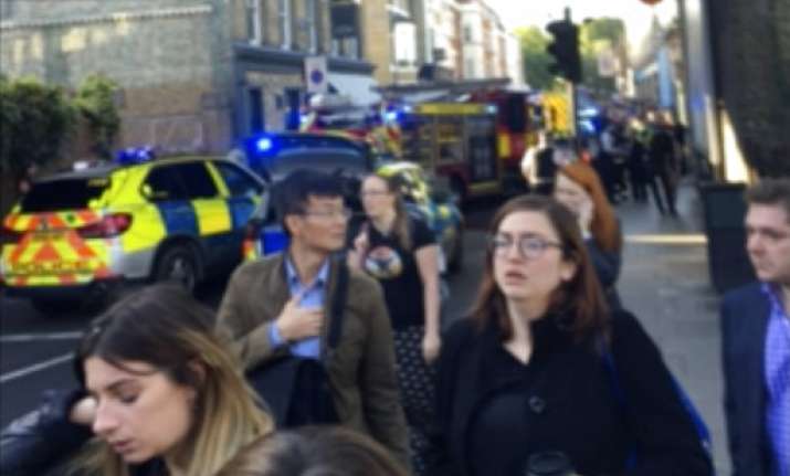 People leave the scene of an explosion