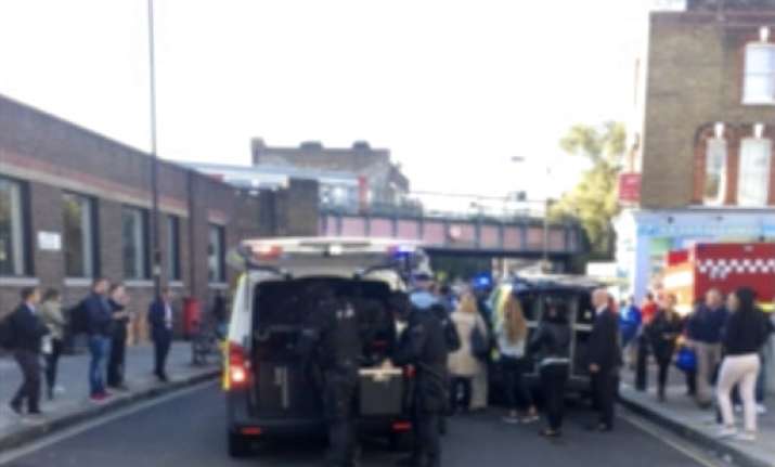 Police officers stand at the scene of a southwest London