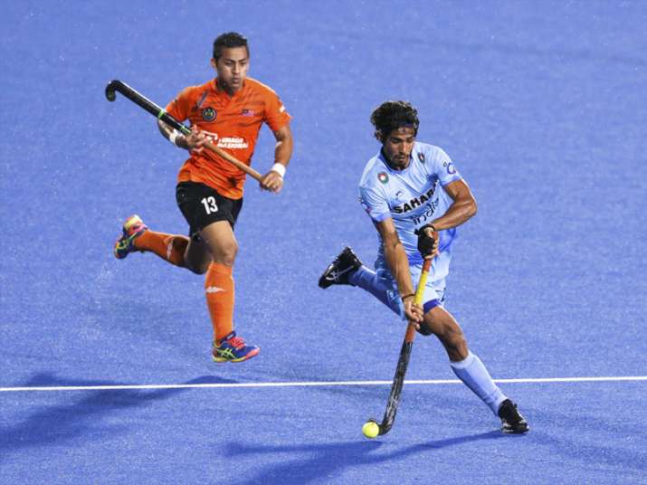Pardeep keeps the ball off Malaysia's Firhan during Sultan