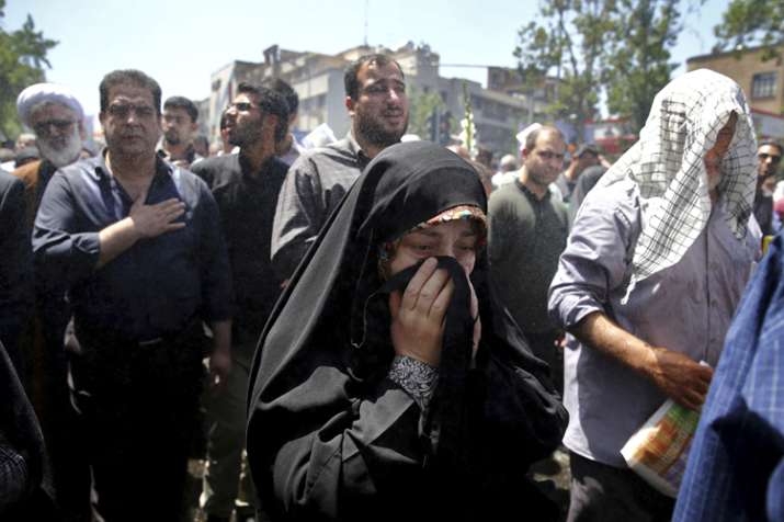 Iranians attend the funeral of victims of an Islamic State