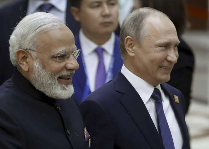 Putin and Modi walk together during a security summit in
