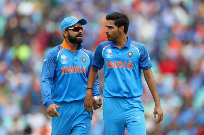 Virat Kohli and Bhuvneshwar Kumar of India chat in the field