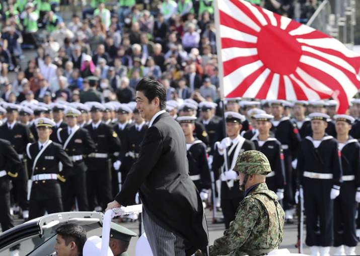 FILE - PM Shinzo Abe reviews members of Japan Self-Defense