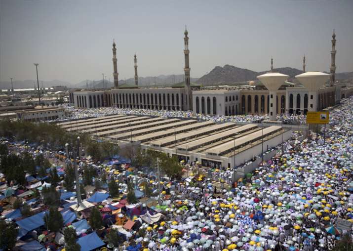 Muslim pilgrims attend noon prayers outside the Namirah