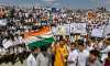 Students wave Tricolour and display placards while