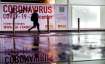 A woman walks past an abandoned coronavirus test center in