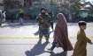 Taliban fighters stand guard after an explosion in Kabul,