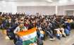 Students, who were about to be rescued, sit with the Indian