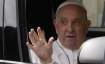 Pope Francis waves from his car as he leaves the Agostino