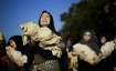 Pro-Palestinian activists perform during a march marking the International Day for the Elimination o