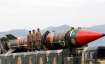 Pakistani military personnel stand beside a Shaheen III surface-to-surface ballistic missile during 