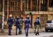 Ugandan security forces patrol on a street in Kampala