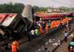 Rescuers work at the site of a passenger trains accident,