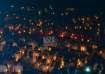 People holding placards and candles take part in a prayer