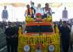 Prime Minister Narendra Modi waves at supporters as he