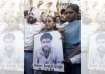 Family members of Sarabjit Singh hold his picture in