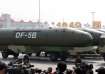 Military vehicles carrying DF-5B intercontinental ballistic missiles travel past Tiananmen Square du