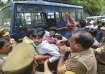 Police personnel detain students during a protest over the