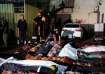 Palestinians check the bodies of their relatives killed in an Israeli bombardment of UNRWA school at