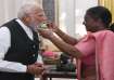 President Murmu feeds 'dahi-cheeni' to Prime Minister-designate Narendra Modi