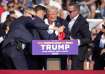 Republican presidential candidate former President Donald Trump is helped off the stage at a campaig