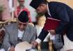 Newly appointed Prime Minister KP Sharma Oli signs a document after taking the oath of office at the