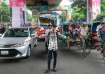 A student directs traffic in Dhaka, Bangladesh