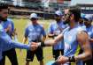 Virat Kohli presents Riyan Parag with his ODI debut cap.