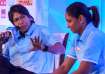 Jhulan Goswami and Harmanpreet Kaur addressing the press at an event.