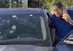 Police officers inspect a car inside of which a hand-held pager exploded, Beirut