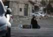 Lebanese woman sitting outside a shelter home