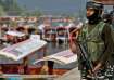 Central Reserve Police Force (CRPF) personnel stand guard on the banks of Dal Lake