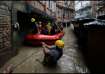 Security force members use an inflatable raft to bring