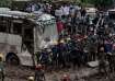 People stranded at the Tribhuwan Highway look on as rescue