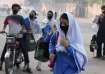 Students wear mask to protect themselves from poor air quality due to increasing smog in the city as