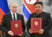 Russia's President Vladimir Putin and North Korea's leader Kim Jong Un pose for a photo after signin