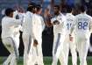 Jasprit Bumrah celebrates a wicket with his teammates.