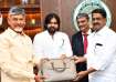 Finance Minister Payyavula Keshav presenting the copies of