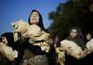 Pro-Palestinian activists perform during a march marking the International Day for the Elimination o