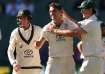 Pat Cummins celebrates a wicket with Mitchell Marsh and Marnus Labuschagne.