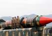 Pakistani military personnel stand beside a Shaheen III surface-to-surface ballistic missile during 