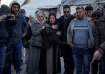 Palestinians react next to the bodies of their relatives who were killed in the Israeli bombardment 