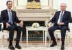 Russian President Vladimir Putin attends a meeting with then-Syrian President Bashar al-Assad at the