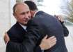 Russian President Vladimir Putin embraces the then-Syrian