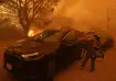 A woman cries as the Palisades Fire advances in the Pacific Palisades neighborhood of Los Angeles