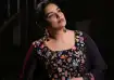 Actress Shwetha Menon wearing a black floral embroidered outfit and statement earrings