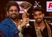 Kalyan Padala holding the Bigg Boss Telugu 9 trophy on the grand finale stage